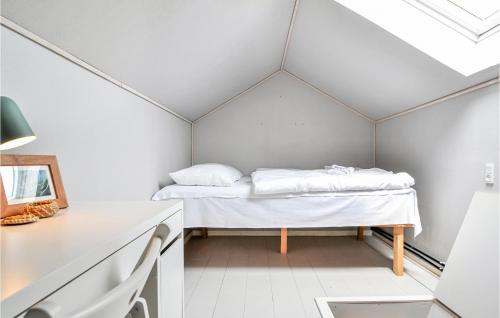 een klein bed in een kamer met een plafond bij 2 Bedroom Beautiful Apartment In Hvide Sande in Hvide Sande