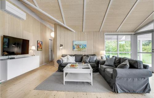 a living room with a couch and a table at Holiday Home Vemb With Fireplace 07 in Vemb