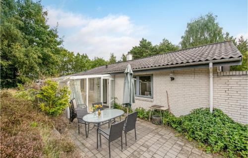 a patio with a table and chairs at Four-Bedroom Holiday Home In Romo in Tagholm
