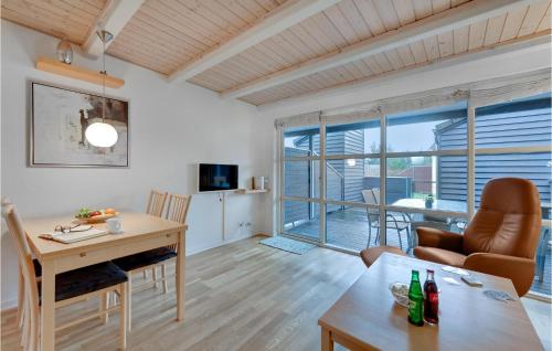 a living room with a table and a dining room at Hus R in Henne Strand