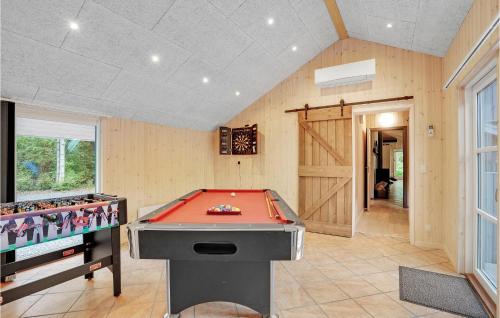 a room with a pool table and a tv at Holiday Home Nordskrænten in Ovtrup