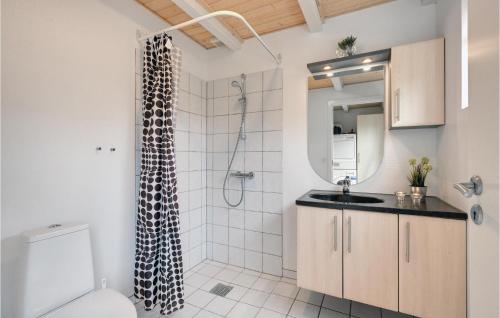 a bathroom with a shower with a toilet and a sink at Hus R in Henne Strand