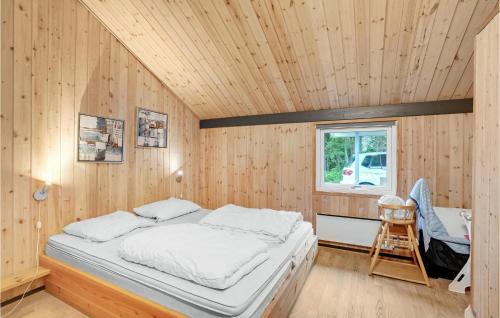 a bedroom with a bed in a wooden room at Holiday Home Nordskrænten in Ovtrup