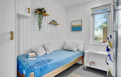 JerupにあるBeautiful Home In Jerup With Wifiのベッドと窓が備わる小さな客室です。