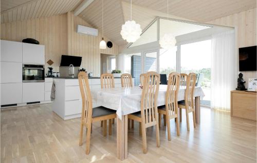 a kitchen and dining room with a table and chairs at Studio Holiday Home In Lokken in Løkken
