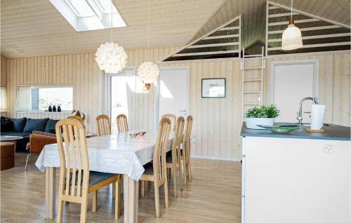 a kitchen and dining room with a table and chairs at Studio Holiday Home In Lokken in Løkken