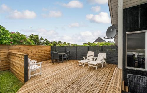 a deck with chairs and a table on a house at Holiday Home Fiskervej Thisted Iv in Thisted