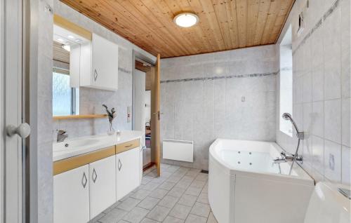 a white bathroom with a tub and a sink at Lovely Home In Thisted With House A Panoramic View in Thisted