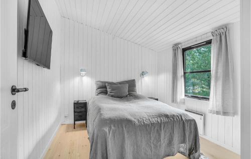 a white bedroom with a bed and a window at Amazing Home In lbk With 3 Bedrooms, Sauna And Wifi in Ålbæk