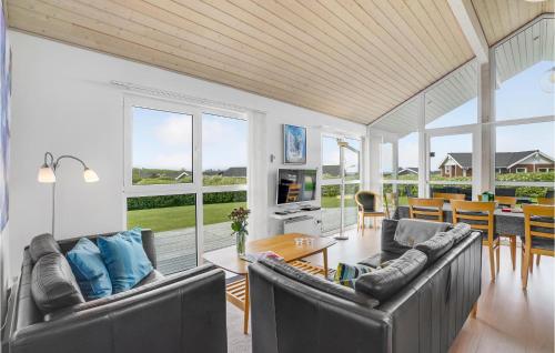 a living room with two couches and a table at Holiday Home Kildebakken Vinderup V in Vinderup