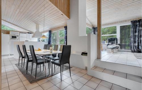 a kitchen and dining room with a table and chairs at Cozy Home In Jerup With Kitchen in Jerup
