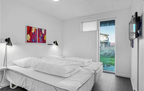 フレデリクスハウンにあるAmazing Home In Frederikshavn With 3 Bedrooms And Wifiの白いベッドルーム(ベッド1台、窓付)