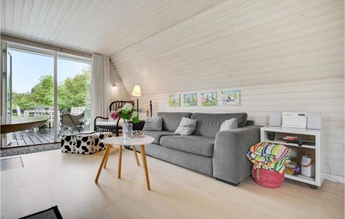 a living room with a couch and a table at Holiday Home Pukkelvej Ebeltoft V in Ebeltoft