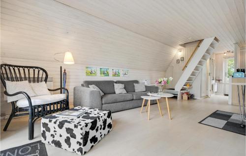 a living room with a couch and a table at Holiday Home Pukkelvej Ebeltoft V in Ebeltoft