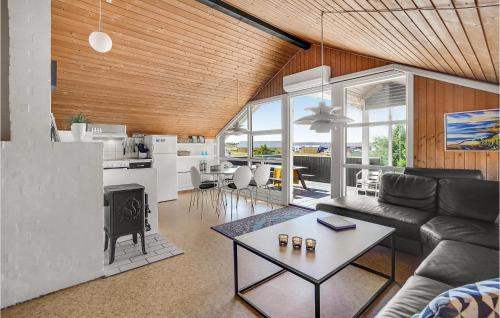 a living room with a couch and a table at Holiday Home Grårisvej Thisted Vi in Nørre Vorupør