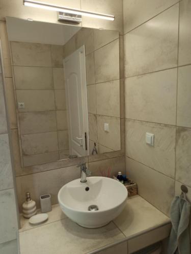 a bathroom with a white sink and a mirror at Diana's Penthouse in Perea