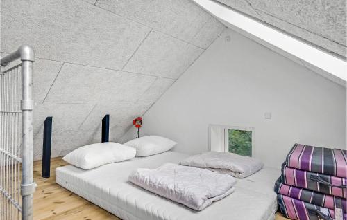 a white room with two pillows on a bed at 4 Bedroom Lovely Home In Knebel in Knebel