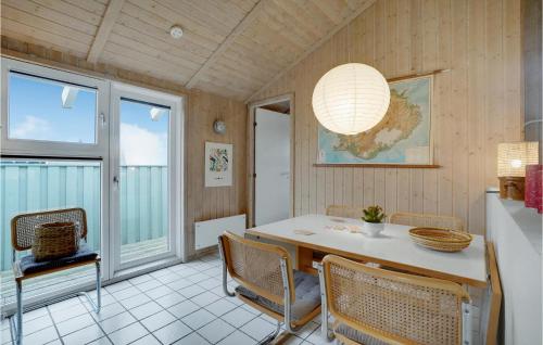 a dining room with a table and chairs at Holiday Home Kløvborgsti Thisted Ix in Klitmøller