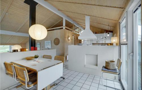 a kitchen and dining room with a table and chairs at Holiday Home Kløvborgsti Thisted Ix in Klitmøller
