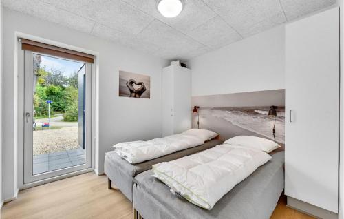 2 Betten in einem Zimmer mit Fenster in der Unterkunft 3 Bedroom Awesome Home In Ringkbing in Ringkøbing