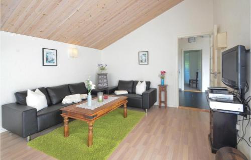 a living room with a couch and a coffee table at Three-Bedroom Holiday Home In Vestervig in Vestervig