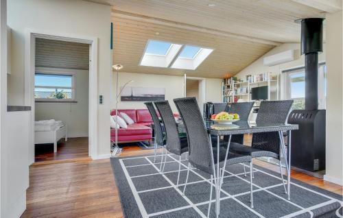 a living room with a table and chairs and a couch at Three-Bedroom Holiday Home In Hjorring in Hjørring