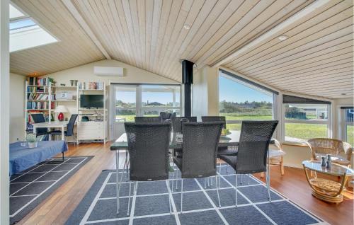 a living room with a table and chairs at Three-Bedroom Holiday Home In Hjorring in Hjørring