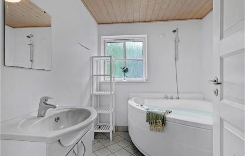 a white bathroom with a tub and a sink at Beautiful Home In Give With Wifi in Give