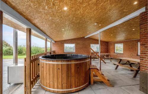 a hot tub in a room with a brick wall at Stunning Home In Hanstholm With Sauna in Hanstholm