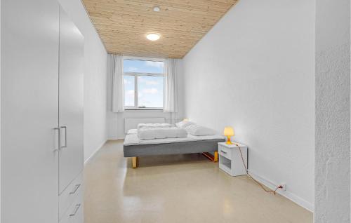 a white room with a bed and a window at Stunning Home In Hanstholm With Sauna in Hanstholm