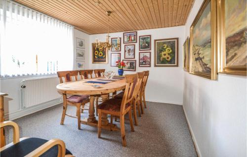 a dining room with a wooden table and chairs at Holiday Home Mariagervej in Randers
