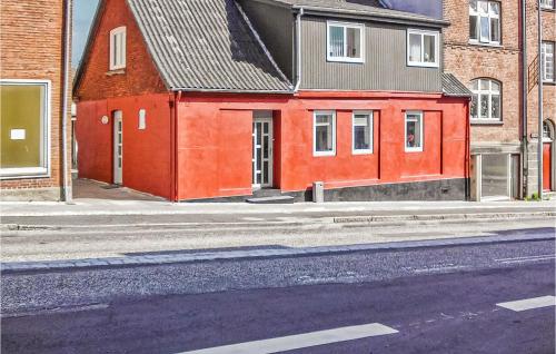 a red building on the side of a street at Holiday Home Mariagervej in Randers