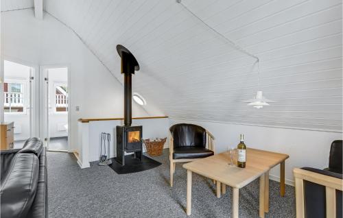 a living room with a wood stove and a table at Marina Fiskenæs Feriepark in Gråsten
