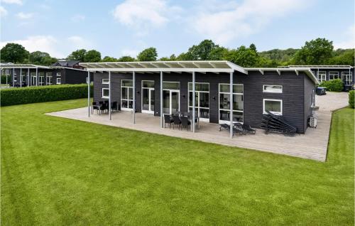 a modular home with a deck and lawn at Holiday Home Podehaven Haderslev in Haderslev