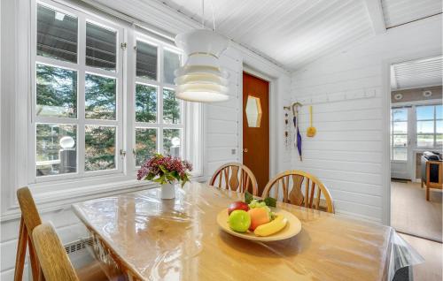 a dining room with a table with a bowl of fruit on it at Holiday Home Venøvej Højslev Denm in Bøstrup