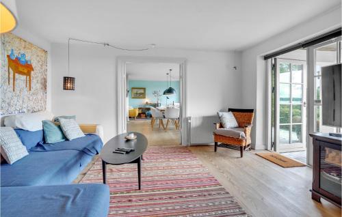a living room with a blue couch and a table at Herligheden in Aabenraa