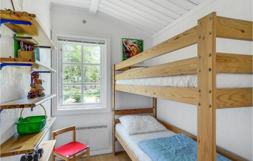 a small bedroom with bunk beds and a desk at 2 Bedroom Lovely Home In Hjslev in Bøstrup