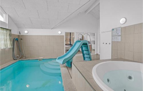 a swimming pool with a slide in a bathroom at 5 Bedroom Beautiful Home In Sydals in Høruphav