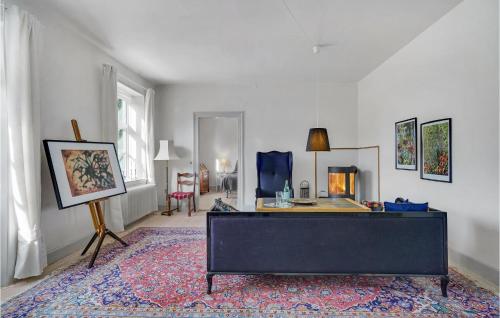 a living room with a table and a rug at 6 Bedroom Gorgeous Home In Kværndrup in Kværndrup