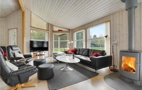 a living room with a couch and a fireplace at Holiday Home Sletten Hadsund Xii in Helberskov