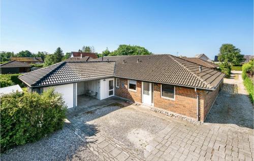 a brick house with a garage in a yard at Gorgeous Home In Millinge With Wifi in Millinge
