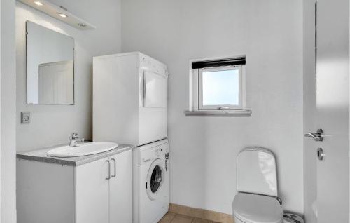 a white bathroom with a sink and a washing machine at Beautiful Home In Faaborg With Sauna in Nabbe