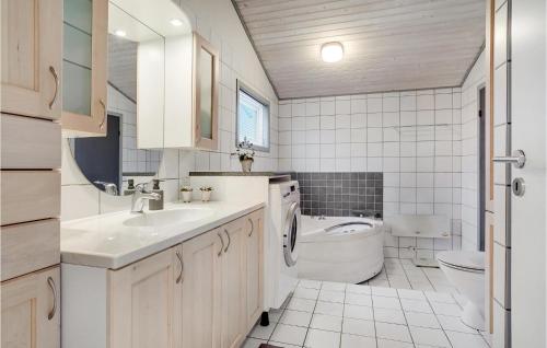 a white bathroom with a sink and a toilet at 4 Bedroom Nice Home In Hadsund in Hadsund
