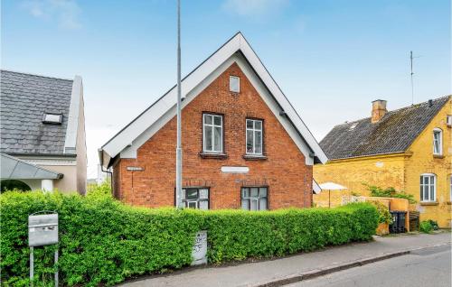 a red brick house with a black roof at 2 Bedroom Cozy Apartment In Svendborg in Svendborg