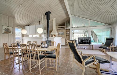 a dining room and living room with a table and chairs at Awesome Home In Blokhus With Wifi in Blokhus