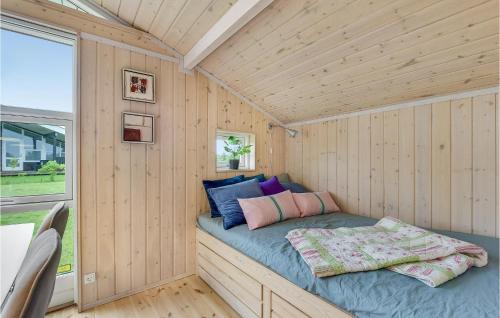 Sønderbyにある3 Bedroom Stunning Home In Juelsmindeの小さな家のベッド ウッドパネル
