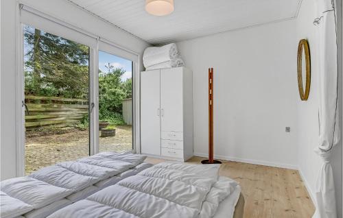 a bedroom with two beds and a large window at Amazing Home In Egå With Kitchen in Egå