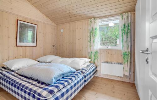 a bedroom with a bed in a room with a window at Nice Home In Storvorde With Kitchen in Storvorde