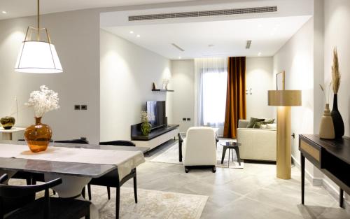 a living room with a dining table and a couch at Boutique Nest in New Cairo in Cairo