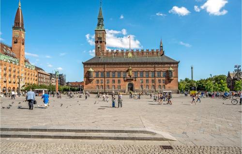 a large brick building with a clock tower at Awesome Apartment In København K in Copenhagen